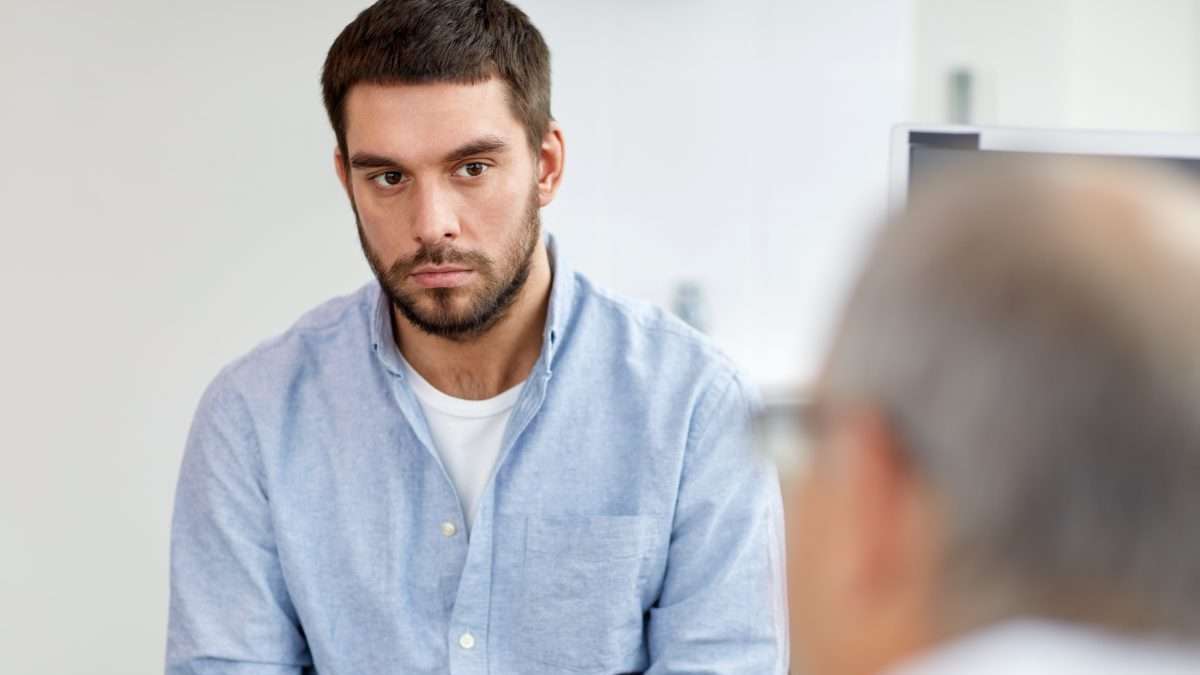Man sitting with doctor