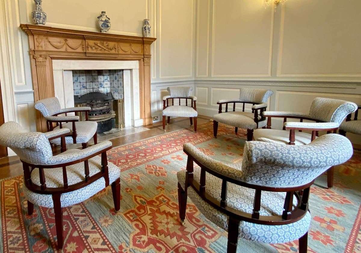 Castle private residential rehab fireplace chairs group therapy room