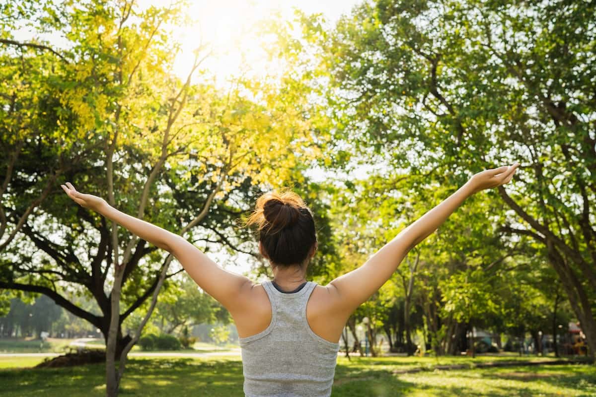 Healthy woman stretching outside in natural beauty