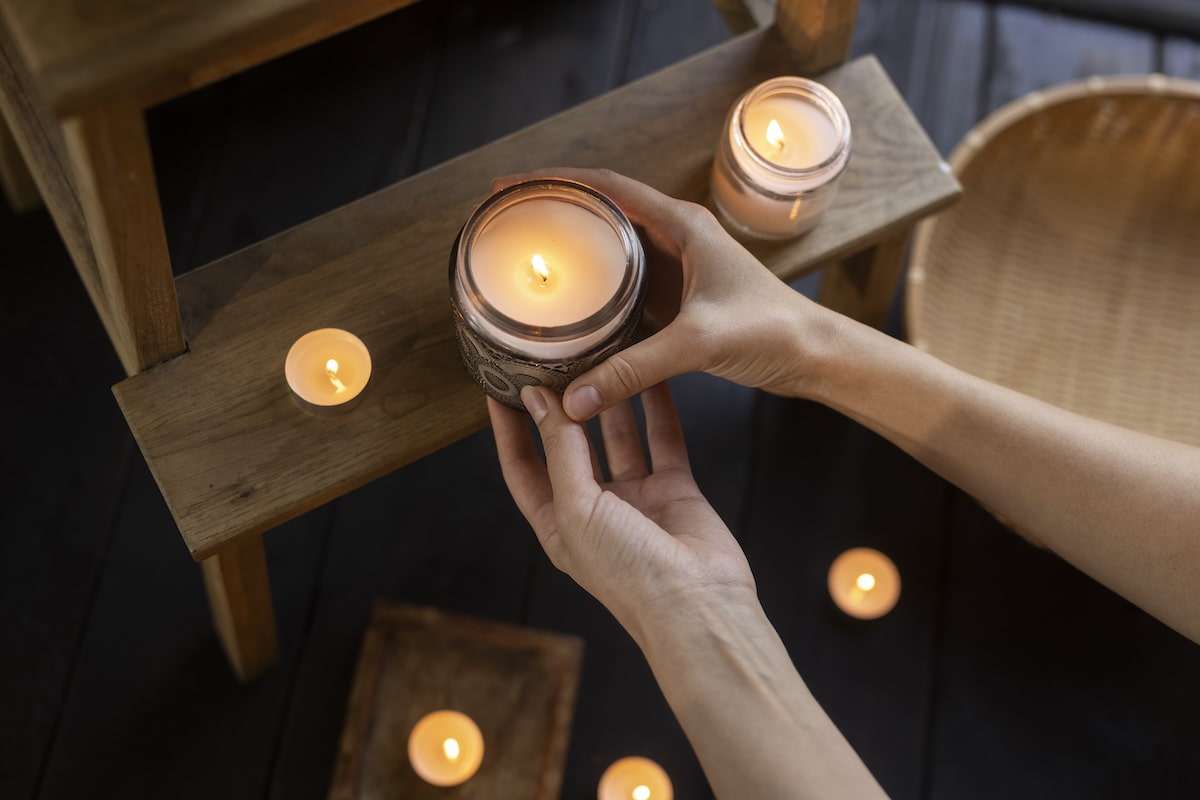 Top view of woman holding candle